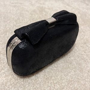 Black clutch with bow design! Chain inside to be used as cross body or clutch!